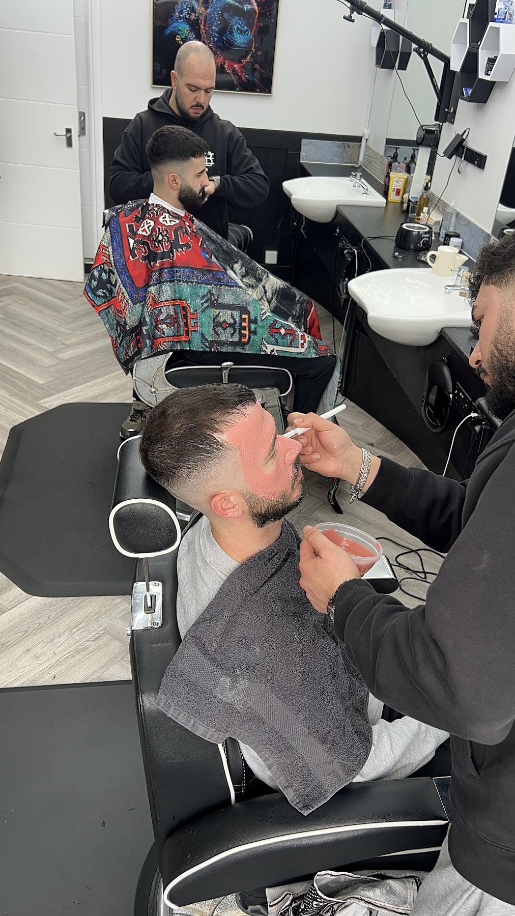 Barber working with a client at Emin's Barbershop